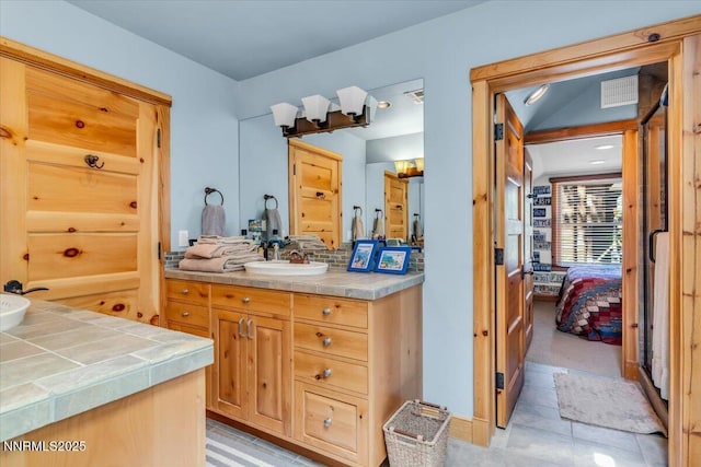 458 Center St, Zephyr Cove, NV 89448 - bathroom with vanity, ensuite bath, backsplash, and tile patterned flooring
