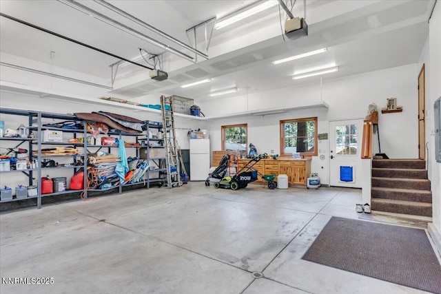 458 Center St, Zephyr Cove, NV 89448 - garage featuring a garage door opener and freestanding refrigerator