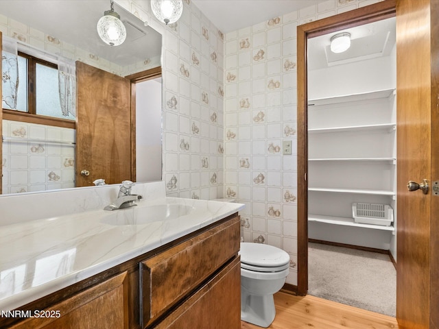 178 Tahoma Cir Unit B, Zephyr Cove, NV 89448 - bathroom featuring wood finished floors, vanity, and wallpapered walls