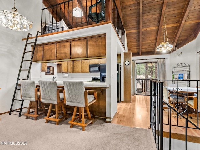 178 Tahoma Cir Unit B, Zephyr Cove, NV 89448 - kitchen featuring high vaulted ceiling, black microwave, a wood ceiling with exposed beams, brown cabinets, and tile countertops