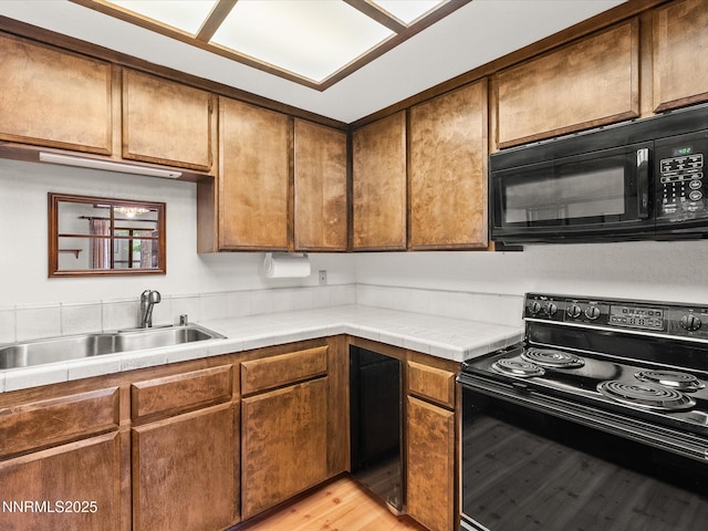 178 Tahoma Cir Unit B, Zephyr Cove, NV 89448 - kitchen featuring black appliances, tile counters, and light wood-style floors
