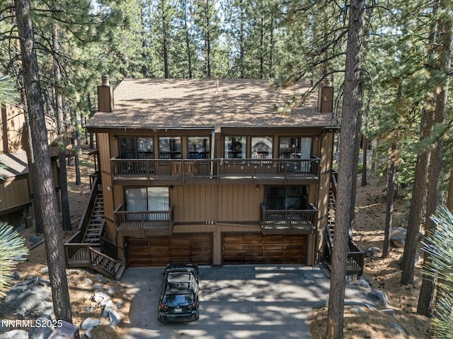 178 Tahoma Cir Unit B, Zephyr Cove, NV 89448 - rustic home with a chimney, a garage, stairs, roof with shingles, and a balcony