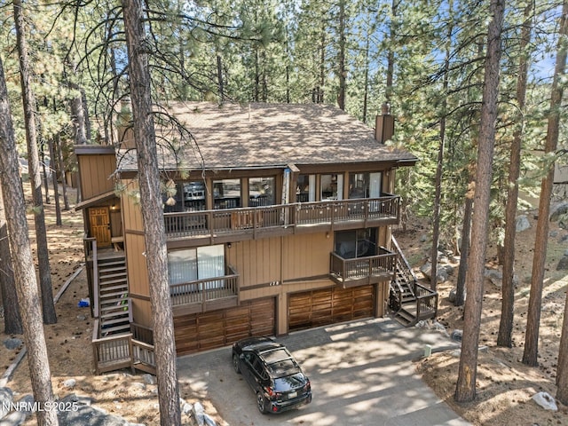 178 Tahoma Cir Unit B, Zephyr Cove, NV 89448 - back of house with stairs, a shingled roof, a chimney, and a balcony