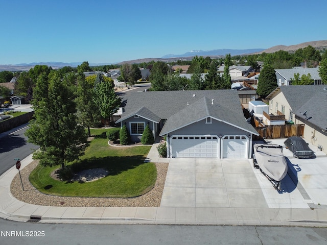 1450 Talon Ct, Spanish Springs, NV 89441 - view of front facade featuring a garage, driveway, a residential view, and a mountain view