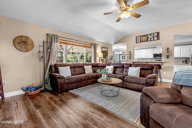 1450 Talon Ct, Spanish Springs, NV 89441 - living area featuring wood finished floors, a chandelier, a ceiling fan, and vaulted ceiling