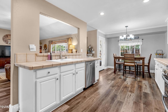 1450 Talon Ct, Spanish Springs, NV 89441 - kitchen featuring dishwasher, white cabinetry, wood finished floors, recessed lighting, and a chandelier
