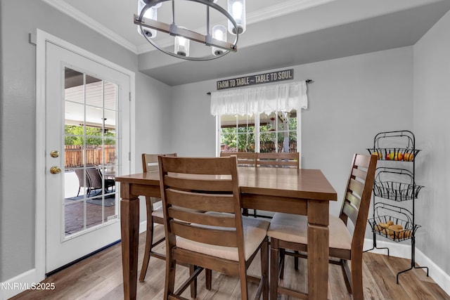 1450 Talon Ct, Spanish Springs, NV 89441 - dining space featuring wood finished floors, healthy amount of natural light, crown molding, and a chandelier