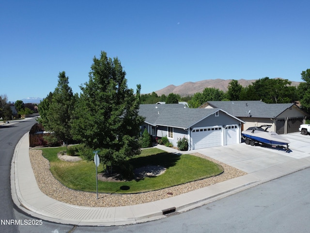 1450 Talon Ct, Spanish Springs, NV 89441 - ranch-style house with an attached garage, a front lawn, concrete driveway, and a mountain view