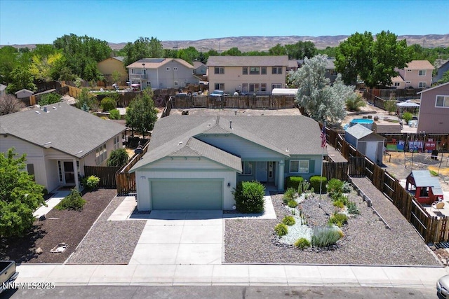 158 Desert Springs Ln, Fernley, NV 89408 - view of front of property with a residential view, a garage, a mountain view, and driveway