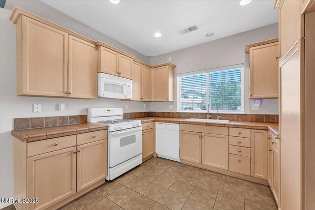 158 Desert Springs Ln, Fernley, NV 89408 - kitchen featuring white appliances, light brown cabinetry, tile countertops, recessed lighting, and light tile patterned flooring