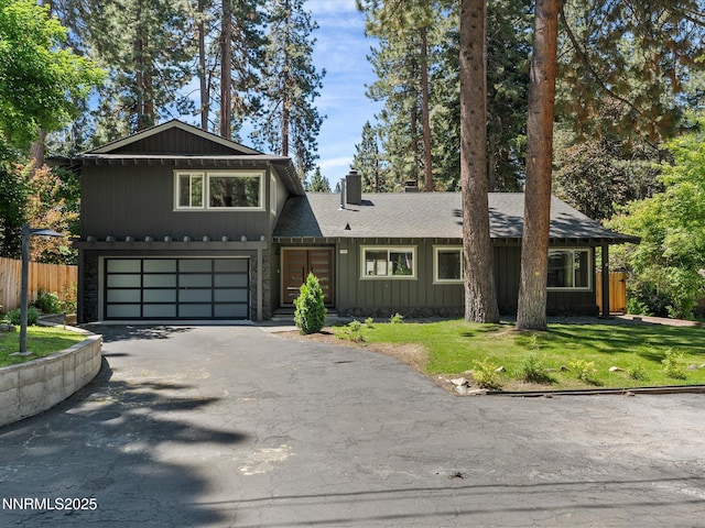 189 Ray Way, Zephyr Cove, NV 89448 - view of front of house with asphalt driveway, a chimney, a garage, and roof with shingles