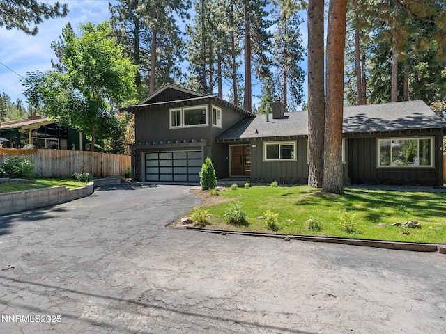 189 Ray Way, Zephyr Cove, NV 89448 - split level home featuring driveway, an attached garage, a chimney, and board and batten siding