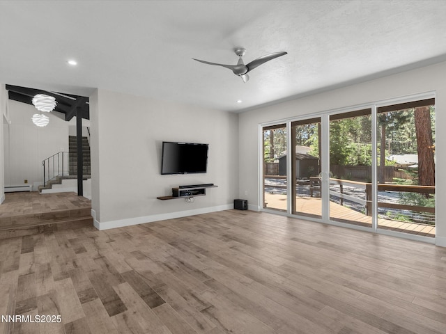 189 Ray Way, Zephyr Cove, NV 89448 - unfurnished living room with baseboard heating, a ceiling fan, stairway, wood finished floors, and recessed lighting
