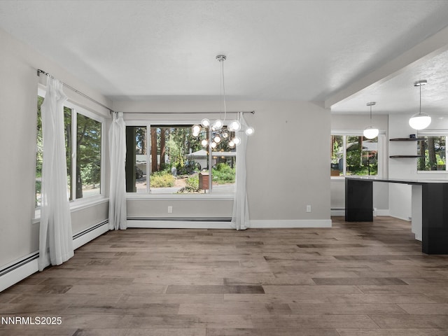 189 Ray Way, Zephyr Cove, NV 89448 - unfurnished dining area with baseboard heating, wood finished floors, a chandelier, and a baseboard radiator