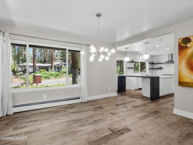189 Ray Way, Zephyr Cove, NV 89448 - kitchen featuring open shelves, baseboard heating, wall chimney range hood, and plenty of natural light