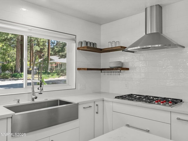 189 Ray Way, Zephyr Cove, NV 89448 - kitchen featuring wall chimney range hood, decorative backsplash, stainless steel gas stovetop, and light countertops