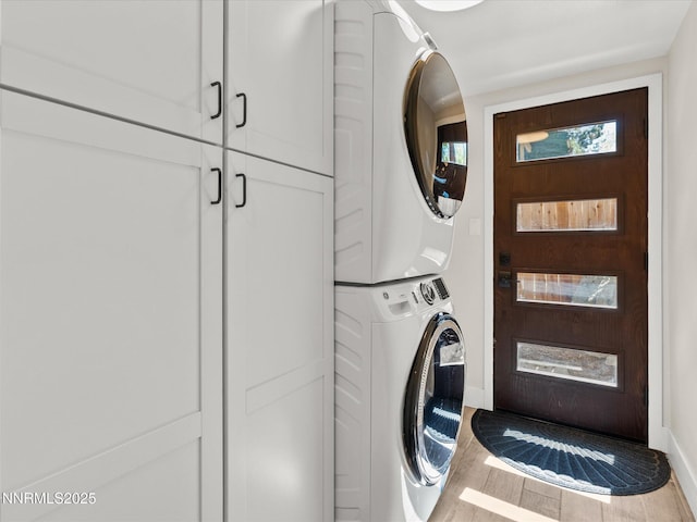 189 Ray Way, Zephyr Cove, NV 89448 - washroom featuring stacked washer and clothes dryer, cabinet space, and wood finished floors