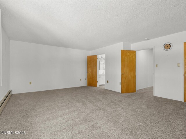 189 Ray Way, Zephyr Cove, NV 89448 - unfurnished living room featuring a textured ceiling, carpet floors, and a baseboard radiator