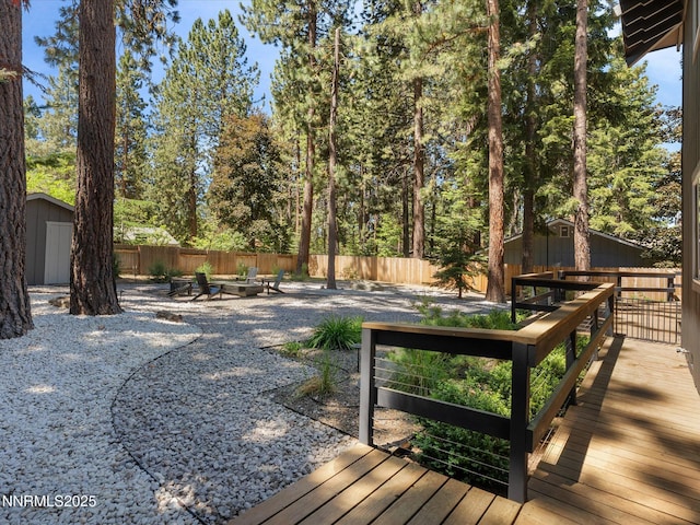 189 Ray Way, Zephyr Cove, NV 89448 - wooden terrace featuring a shed, an outdoor fire pit, and a fenced backyard