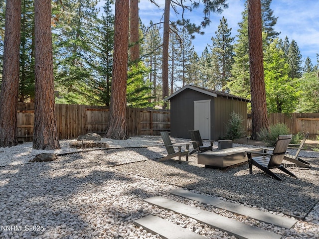189 Ray Way, Zephyr Cove, NV 89448 - fenced backyard featuring a storage unit, an outdoor fire pit, and a patio area