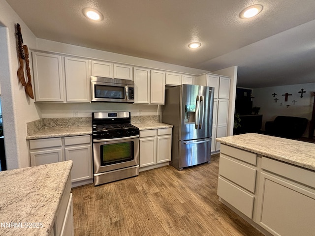 1175 La Cresta Ct, Sparks, NV 89436 - kitchen with stainless steel appliances, light wood finished floors, light countertops, recessed lighting, and white cabinets