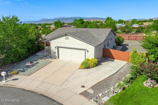7202 Leonardo Ct, Sun Valley, NV 89433 - ranch-style house featuring a garage, driveway, a mountain view, and a shingled roof