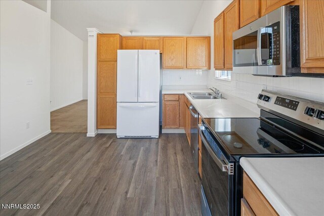 7202 Leonardo Ct, Sun Valley, NV 89433 - kitchen with appliances with stainless steel finishes, dark wood-type flooring, decorative backsplash, and light countertops