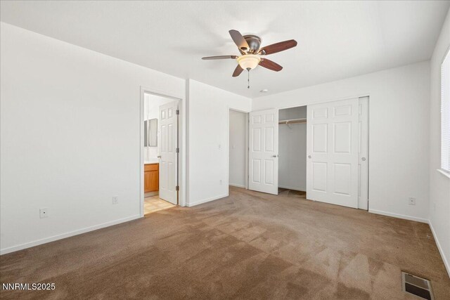 7202 Leonardo Ct, Sun Valley, NV 89433 - unfurnished bedroom with light colored carpet, a closet, ensuite bath, and a ceiling fan