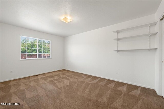 7202 Leonardo Ct, Sun Valley, NV 89433 - carpeted spare room featuring baseboards