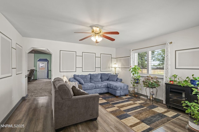 610 Hunter Park Way, Fallon, NV 89406 - living room with a ceiling fan, arched walkways, and dark wood-style flooring