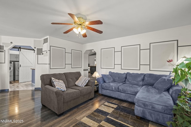 610 Hunter Park Way, Fallon, NV 89406 - living area featuring a barn door, washing machine and clothes dryer, arched walkways, ceiling fan, and wood finished floors