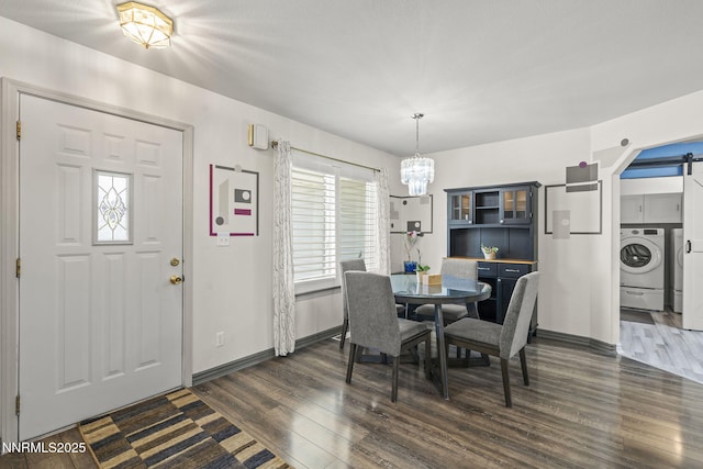 610 Hunter Park Way, Fallon, NV 89406 - dining room with washer / clothes dryer, dark wood-style flooring, a chandelier, and a barn door