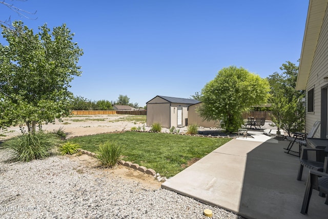 610 Hunter Park Way, Fallon, NV 89406 - fenced backyard featuring a patio and a storage unit