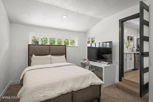 1203 Stanford Way, Sparks, NV 89431 - bedroom featuring lofted ceiling, multiple windows, and carpet flooring