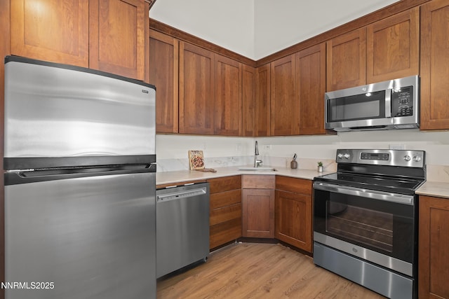 400 Fairview Blvd Unit 20, Incline Village, NV 89451 - kitchen with stainless steel appliances, light wood-style floors, light countertops, and brown cabinetry