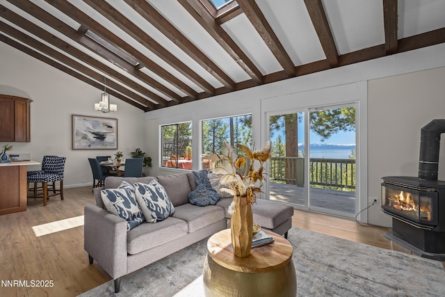 400 Fairview Blvd Unit 20, Incline Village, NV 89451 - living room featuring a wood stove, beamed ceiling, light wood-type flooring, a chandelier, and high vaulted ceiling