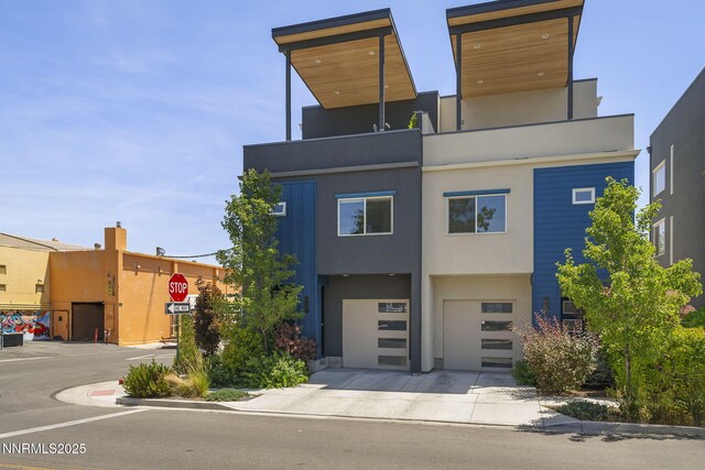 1402 Tonopah St, Reno, NV 89509 - contemporary house featuring an attached garage, driveway, and stucco siding