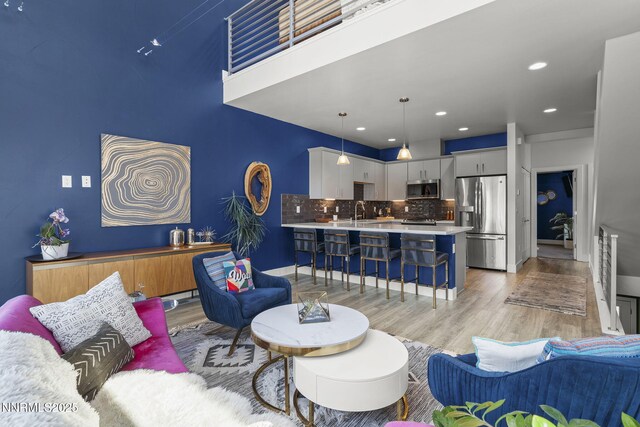 1402 Tonopah St, Reno, NV 89509 - living room featuring light wood-style flooring and recessed lighting