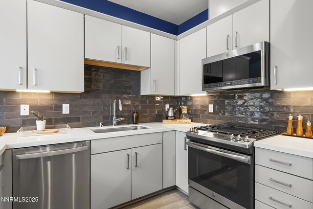 1402 Tonopah St, Reno, NV 89509 - kitchen with appliances with stainless steel finishes, light countertops, decorative backsplash, and white cabinets