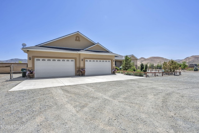 150 Brandon Ranch Ct, Reno, NV 89510 - view of front of home featuring concrete driveway, stucco siding, a mountain view, and an attached garage