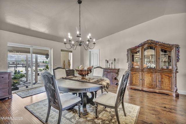 150 Brandon Ranch Ct, Reno, NV 89510 - dining room featuring a chandelier, vaulted ceiling, and dark wood finished floors