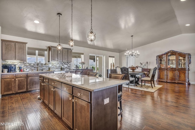 150 Brandon Ranch Ct, Reno, NV 89510 - kitchen featuring a kitchen bar, a chandelier, a center island, dark wood-type flooring, and lofted ceiling