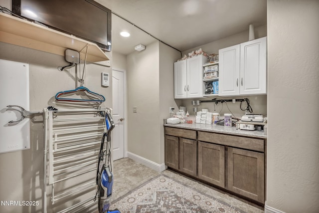 150 Brandon Ranch Ct, Reno, NV 89510 - kitchen featuring white cabinets, light tile patterned floors, open shelves, and light stone countertops