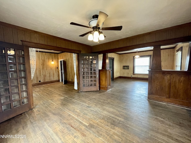77 Lay St, Winnemucca, NV 89445 - unfurnished living room with wooden walls, wood finished floors, and ceiling fan
