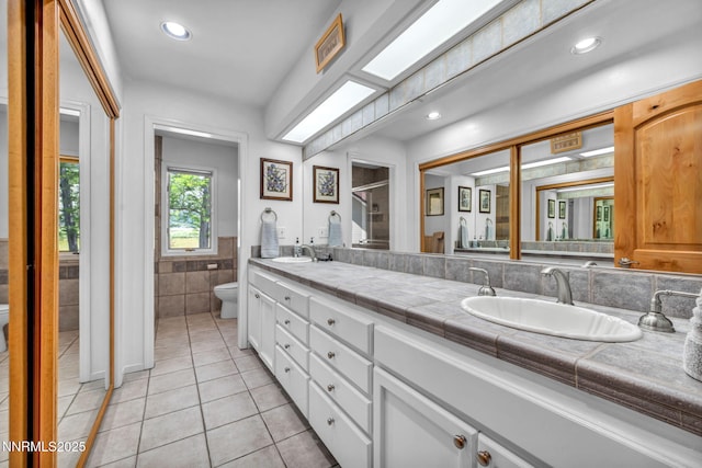 1008 Georgia Ln, Gardnerville, NV 89460 - full bathroom with tile walls, double vanity, tile patterned floors, a shower with shower door, and recessed lighting