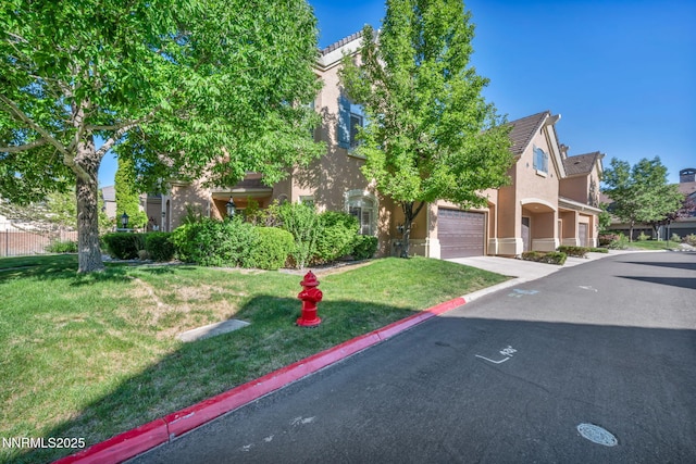 9900 Wilbur May Pkwy Unit 2001, Reno, NV 89521 - obstructed view of property featuring stucco siding, a front lawn, and driveway