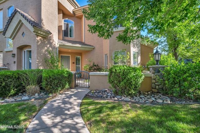 9900 Wilbur May Pkwy Unit 2001, Reno, NV 89521 - view of front of property with a gate, stucco siding, and a fenced front yard