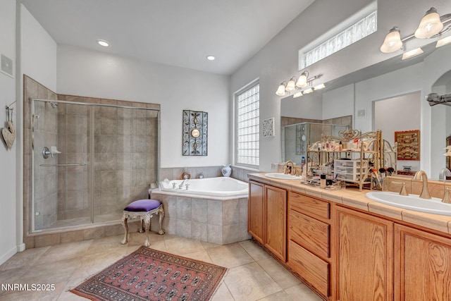 9900 Wilbur May Pkwy Unit 2001, Reno, NV 89521 - full bathroom featuring a bath, a shower stall, double vanity, tile patterned flooring, and recessed lighting