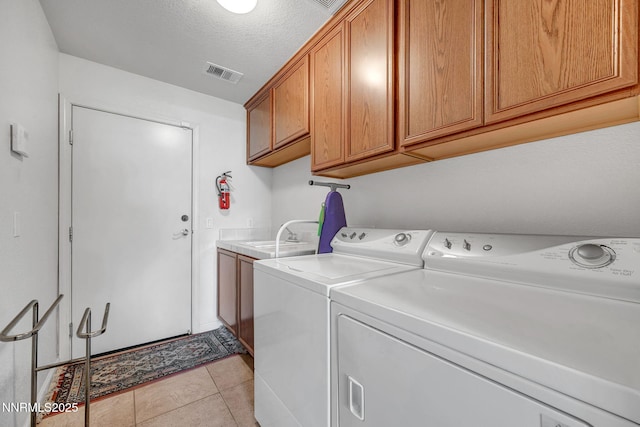 9900 Wilbur May Pkwy Unit 2001, Reno, NV 89521 - washroom featuring cabinet space, independent washer and dryer, light tile patterned floors, and a textured ceiling