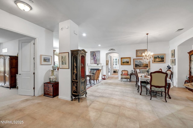 9900 Wilbur May Pkwy Unit 2001, Reno, NV 89521 - dining space featuring arched walkways, recessed lighting, a fireplace, a chandelier, and light tile patterned floors